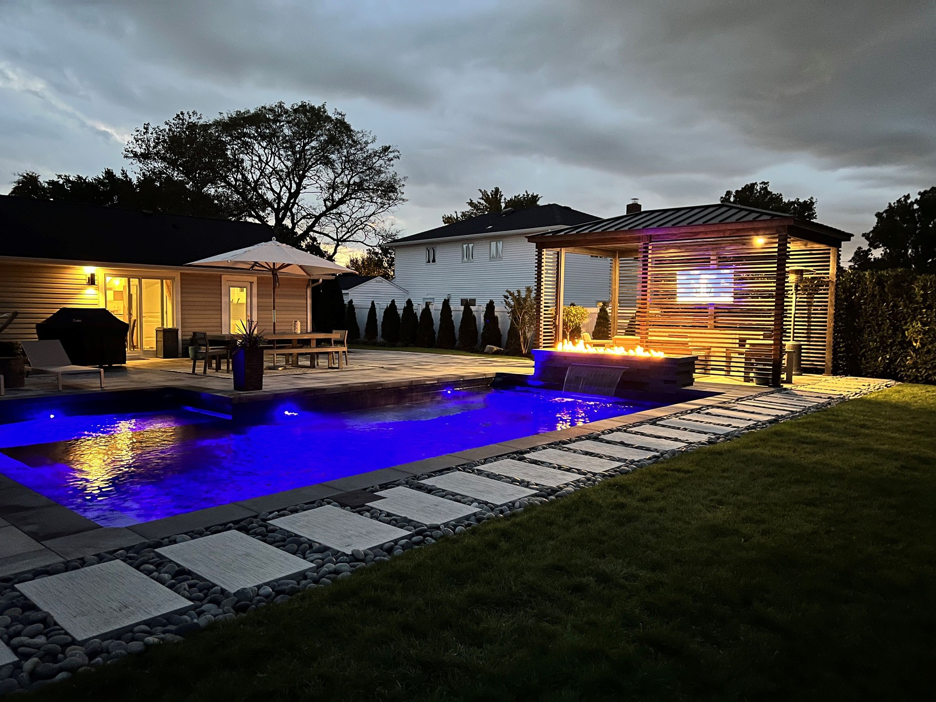 Gorgeous modern backyard at night, perfect lighting design and aesthetics